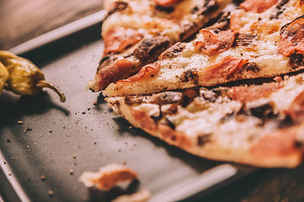 istock Homemade Pizza Slices with ham and mushrooms 484317892