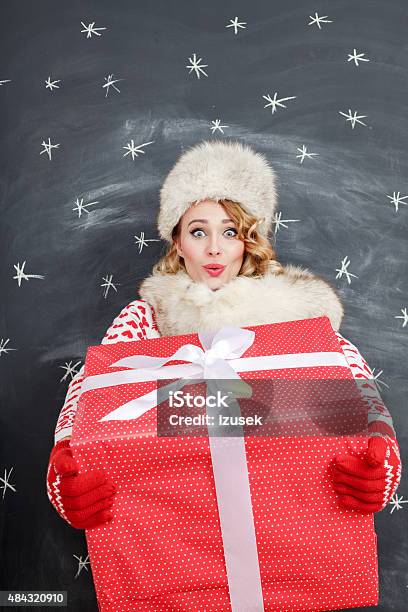 Happy Blonde Woman In Winter Outfit With Christmas Gift Stock Photo - Download Image Now
