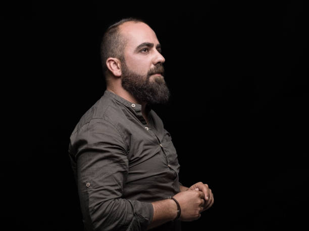 istock Thoughtful man portrait over black background 484321462