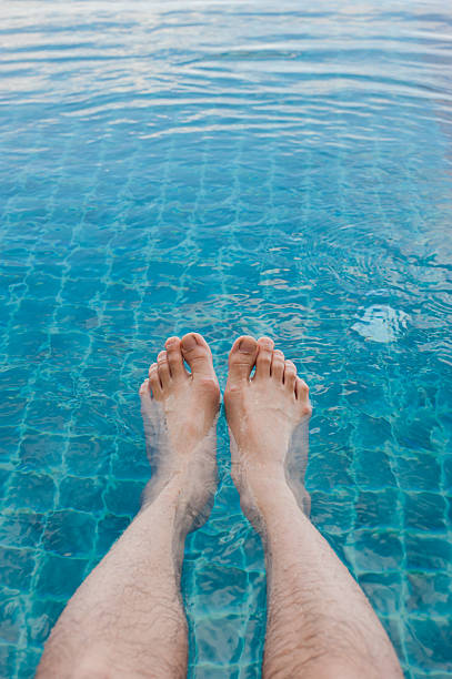 istock Relaxing legs in swimming pool 484323041