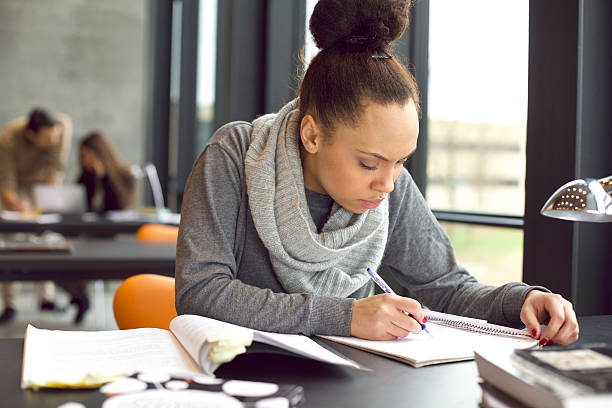 istock Young african american woman taking notes for her study 484323257