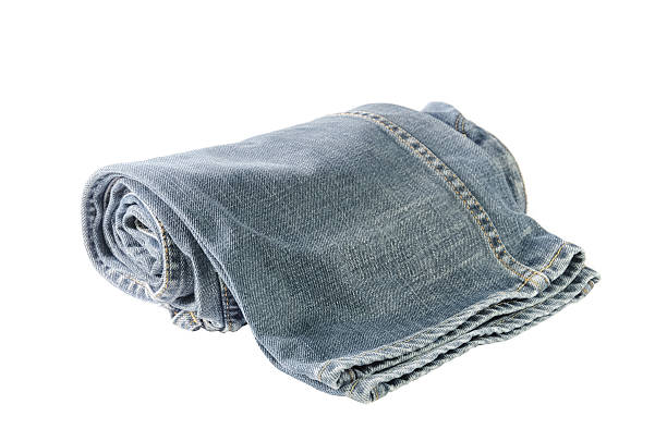 istock Rolls of Blue Jeans isolated on white background 484323472
