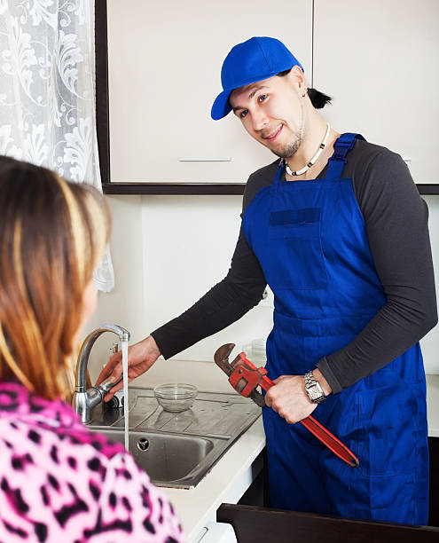 istock Girl watching as man repairing 484327073