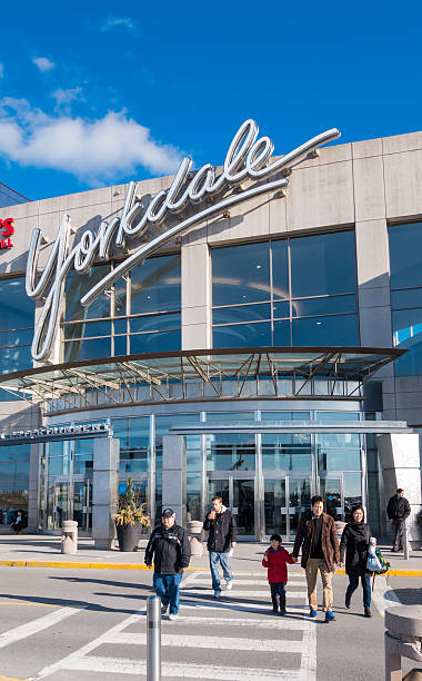 Toronto, Canada - April 5, 2014: People crossing street after exiting Yorkdale Shopping Centre. The mall contains over 250 stores and is celebrating its 50th year anniversary in 2014.