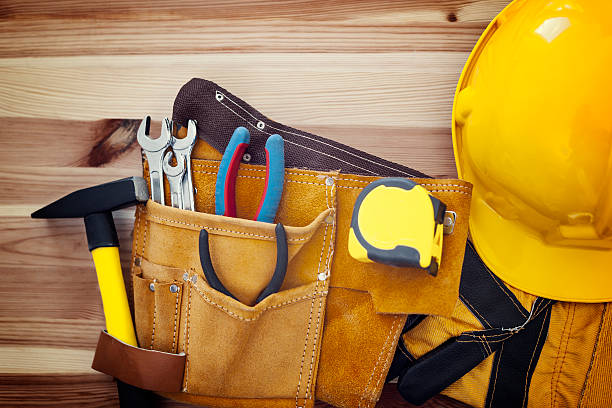 istock Belt with tools and yellow helmet on wood 484327585
