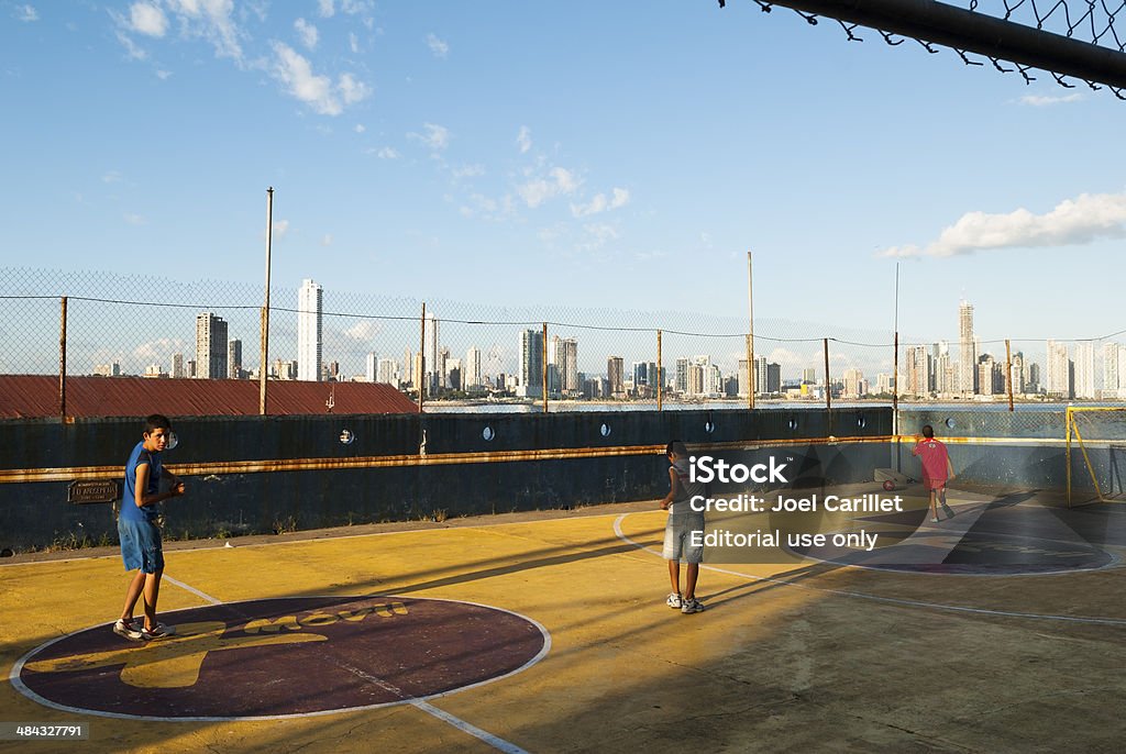 Soccer in Panama City, Panama Panama City, Panama - December 21, 2008: Three boys play soccer in the Casco Viejo district of Panama City, Panama. The city skyline is in the background Activity Stock Photo