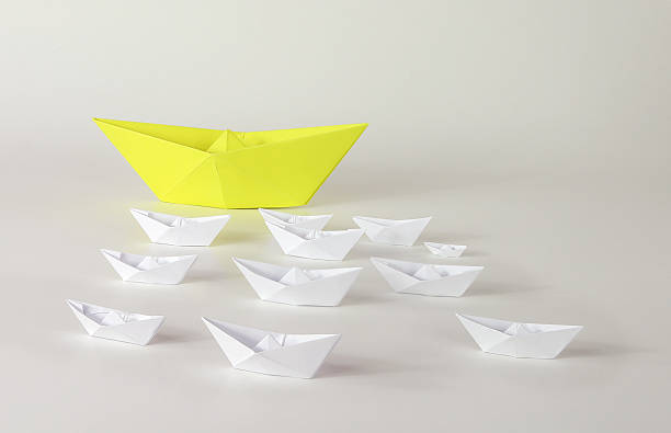 istock Yellow paper ships origami 484327843