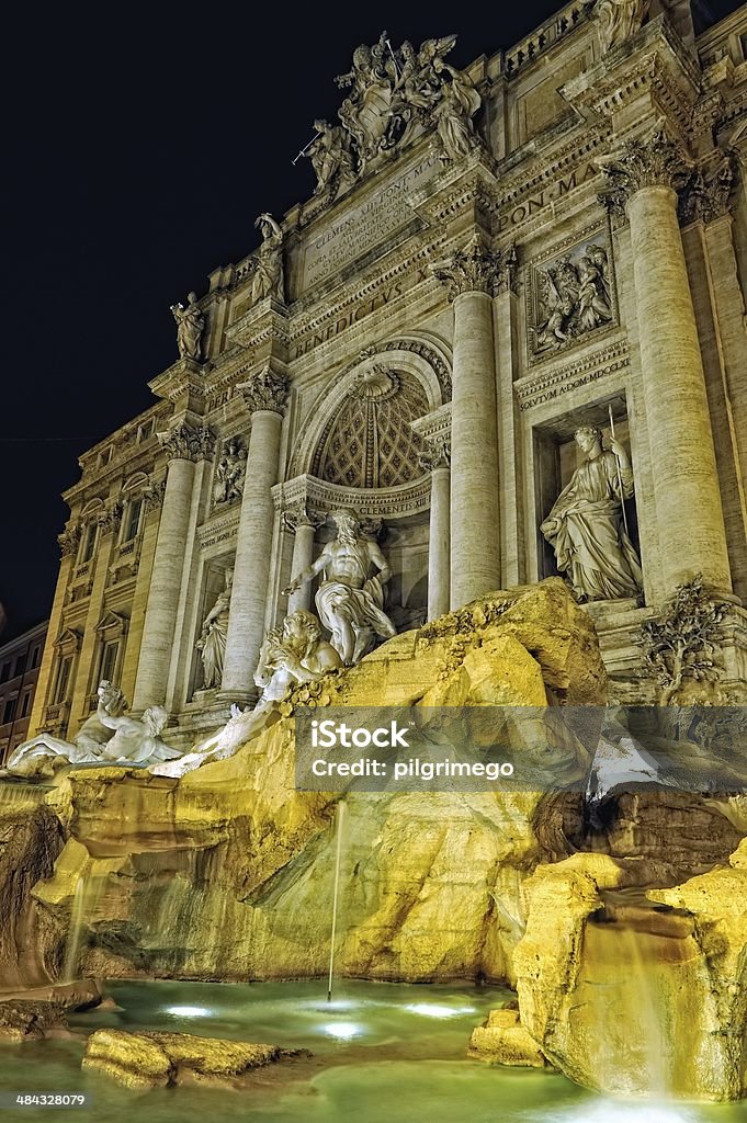 Night lighting of Trevi fountain in Rome, Trevi fountain in Rome, Iraly. Beautiful lighting of night time. Ancient Stock Photo