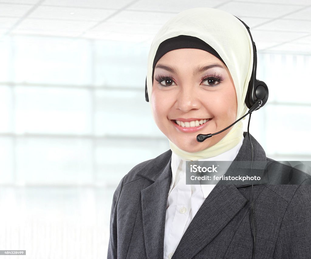 beautiful Muslim woman customer service operator close up portrait of Young beautiful Muslim woman customer service operator with headset on white background Adult Stock Photo