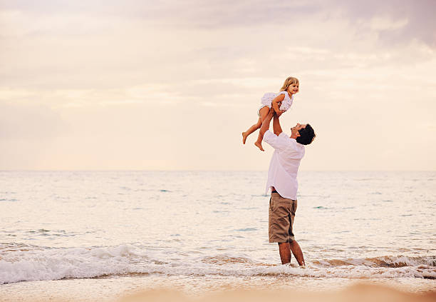 istock Father and Daughter Playing Together at the Beach at Sunset 484328939
