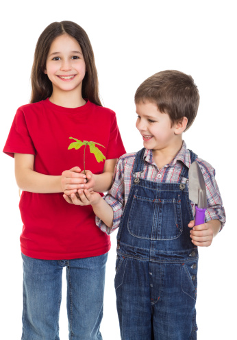 Smiling kids with oak sapling in hands, isolated on white