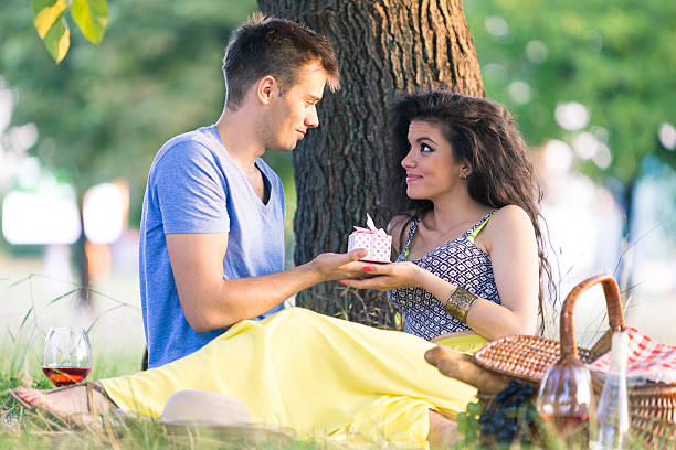 istock Couple having picnic in the park 484333616