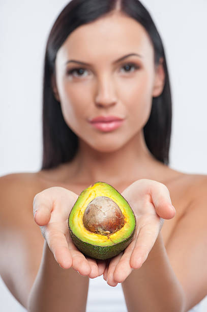 istock Cheerful young girl is showing exotic fruit 484334186