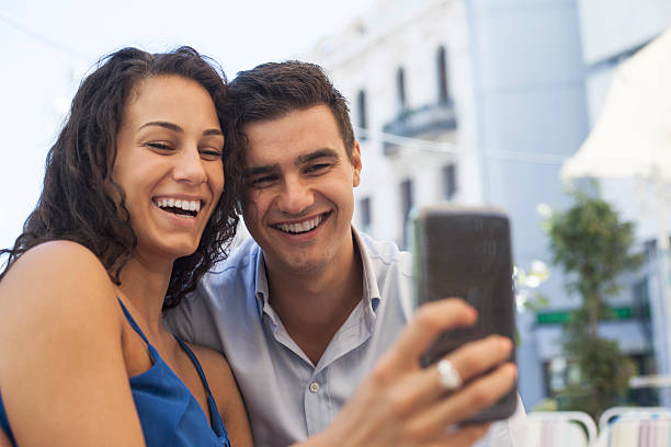 istock Happy couple looking at mobile phone 484334590