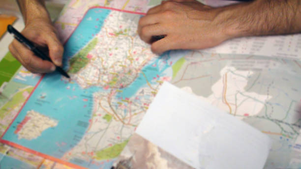 istock Tourist Checking City Paper Map For Direction 484335336