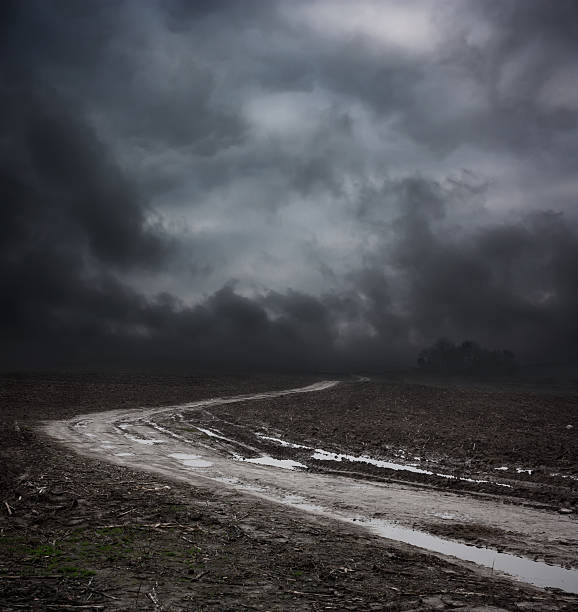 Dark Landscape with Dirty Road and Moody Sky stock photo