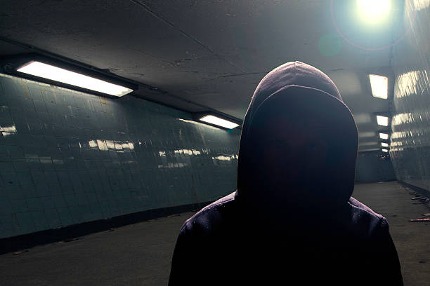 istock Hoodie gangster in subway (face in shadow) 484341709