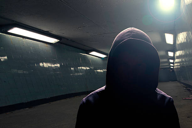 Hoodie gangster in subway (face in shadow) stock photo