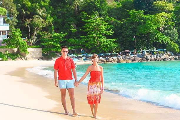 istock Young romantic couple walking on exotic beach in sunny day 484341821