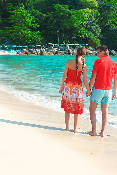 istock Back view of Young couple enjoying each other on beach 484341827