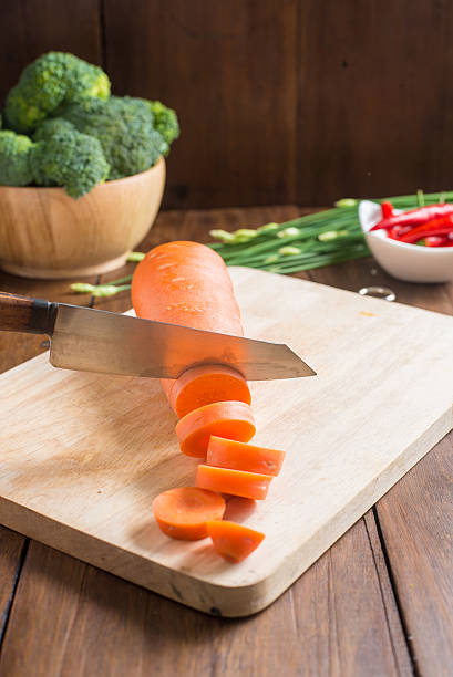 fresh carrot on cutting board on wooden background