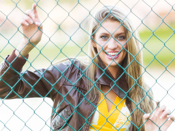 istock Smiling girl behind the fence 484343871