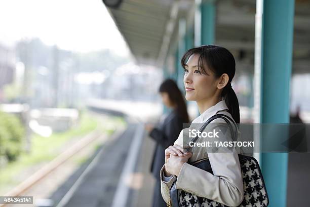 Woman Waiting For Train On The Platform Stock Photo - Download Image Now - Railroad Station Platform, Japan, Station