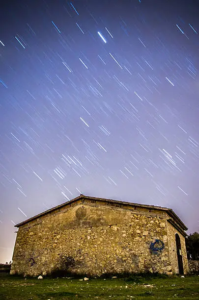 star trail over a old rural house