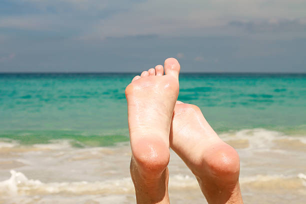 istock Women's beautiful legs background the turquoise water 484346067
