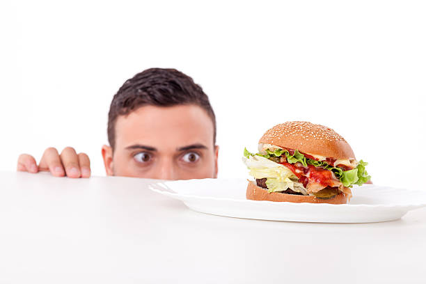 istock Attractive pretty young man is very hungry 484346742