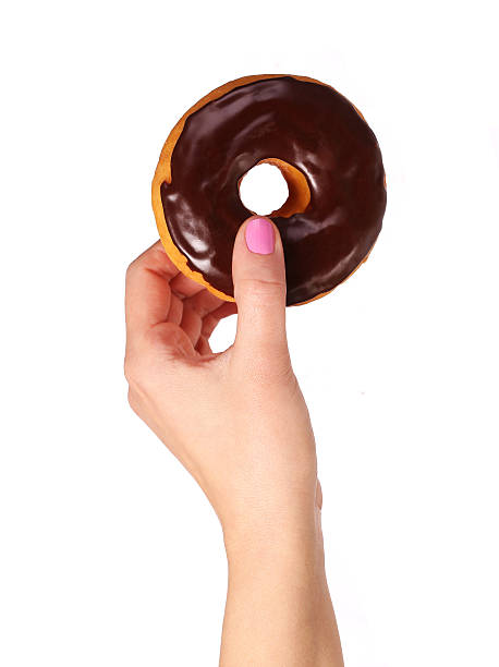 istock Donut with chocolate glazing in hand isolated 484347172