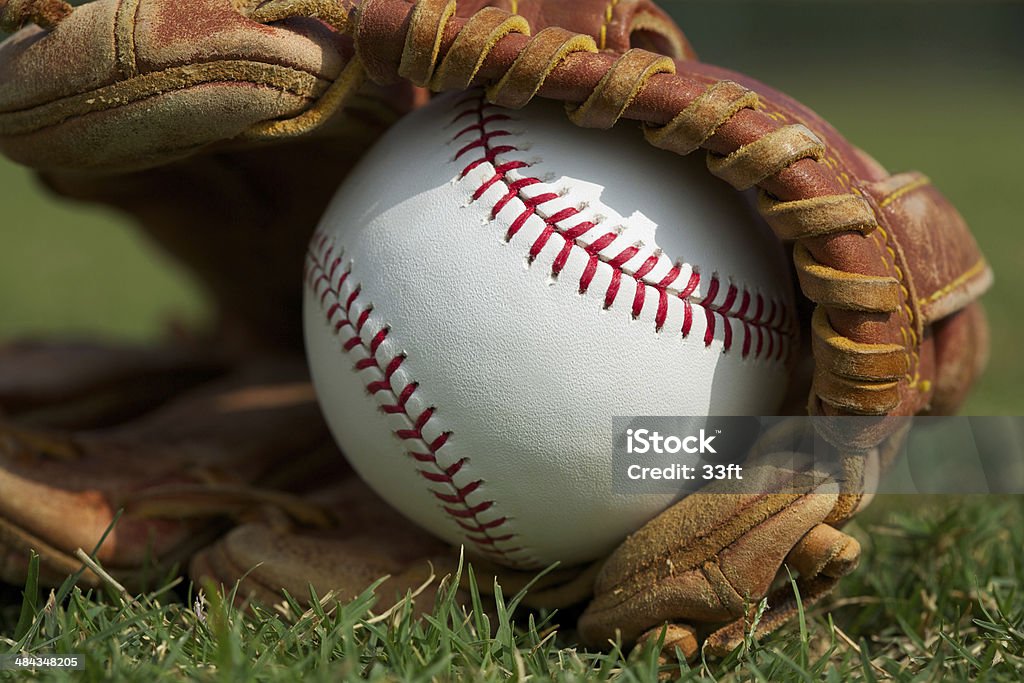 Baseball in a Glove New Baseball in a Glove in the Outfield Youth Baseball Stock Photo