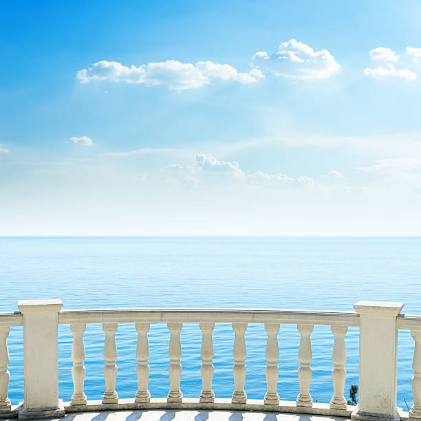 istock white balcony on sea beach and clouds in sky 484354128