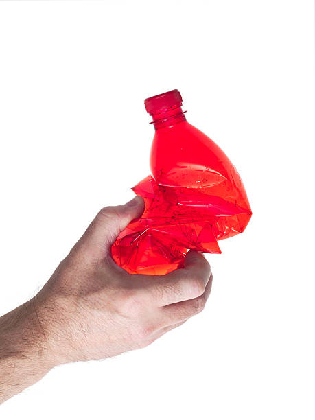 istock hand of man tightens a red plastic bottle 484357152