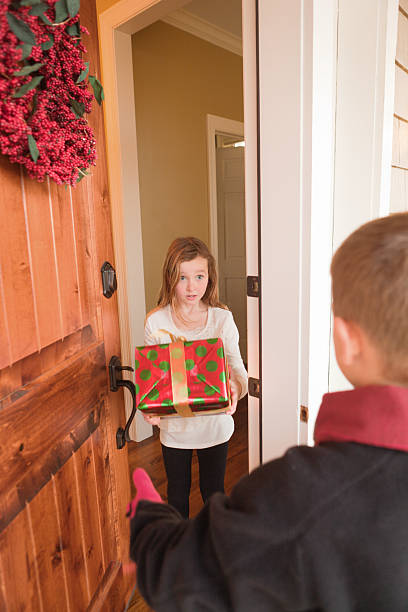 istock Children Surprise Christmas Gift Visit at Front Door 484369992