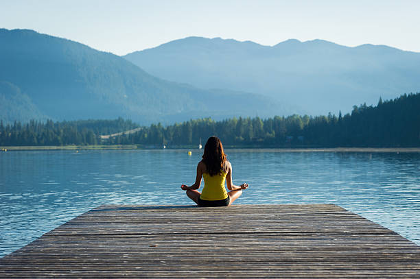 istock Easy Pose Tranquil Lakeside meditation at sunrise 484370052