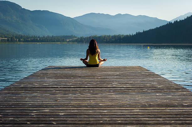 istock Easy Pose Tranquil Lakeside meditation at sunrise 484370056