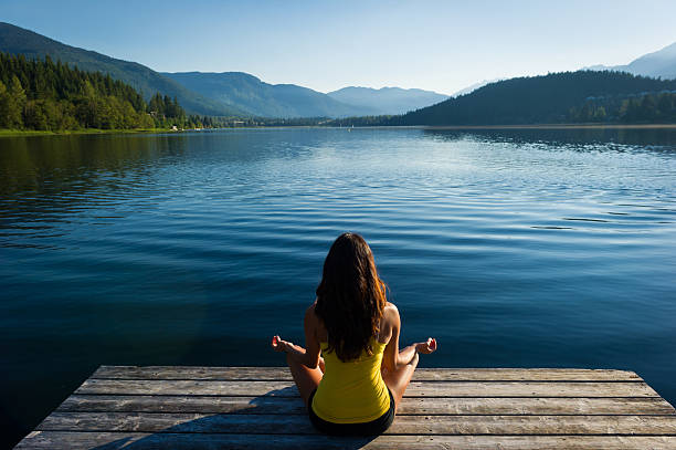 istock Easy Pose Tranquil Lakeside meditation at sunrise 484370058