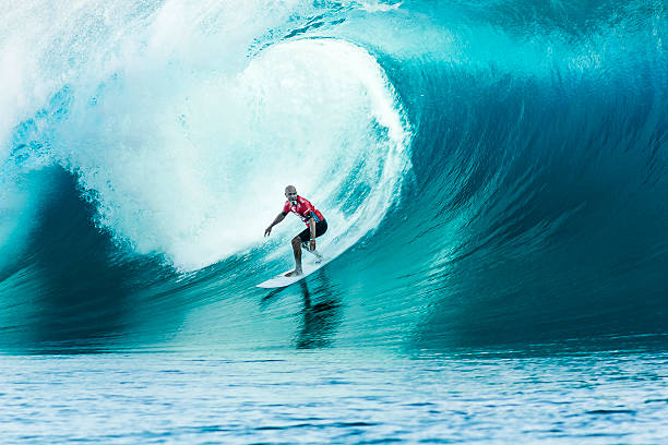 Surfer Kelly Slater Surfing 2014 Billabong Pro Tahiti Tahiti, French Polynesia, - August 24, 2014: Surfer Kelly Slater Surfing 2014 Billabong Pro Tahiti in Teahupoʻo Beach carrying a GoPro Camera in his mouth, indo pacific ocean stock pictures, royalty-free photos & images