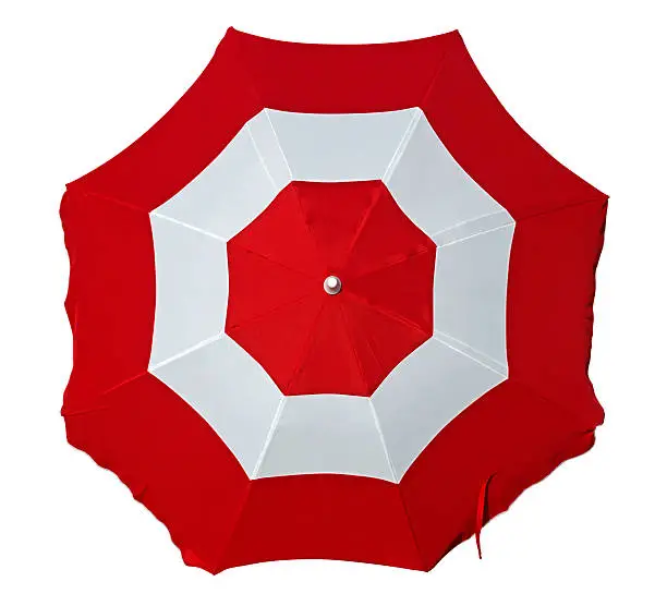 Opened beach umbrella with red and white stripes isolated on white. Top view. Clipping path included.