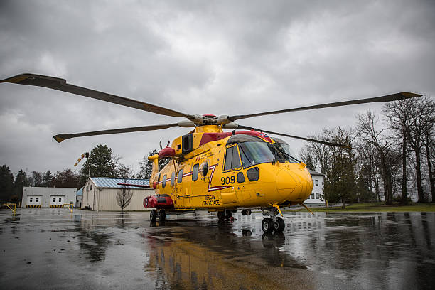 Canadian Search & Rescue Helicopter Vancouver, Canada - Mar 8, 2014: A Canadian Forces "Cormorant" Search and Rescue (SAR) helicopter on the helicopter pad of the Naval Reserve Unit HMCS Discovery in Vancouver, British Columbia on a rainy spring day in 2014. Canadian Forces search and rescue technicians and the Canadian Coast Guard were on a joint search and rescue exercise on the coast of British Columbia to prepare for emergencies. cormorant stock pictures, royalty-free photos & images