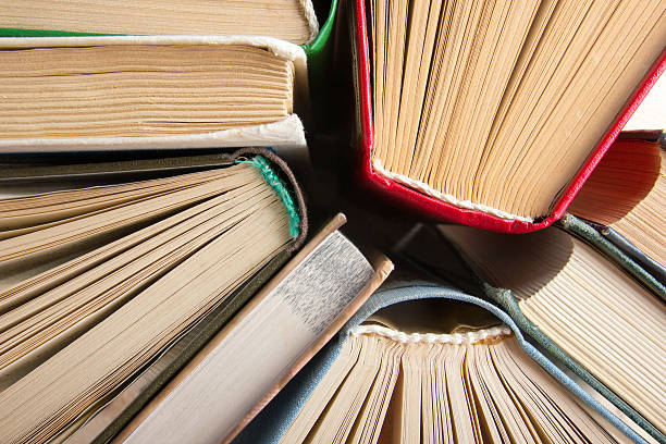 istock Top view of old used colorful hardback books. 484373854