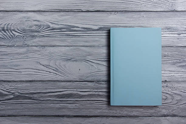 istock Blank book cover on textured wood background. Copy space 484373856