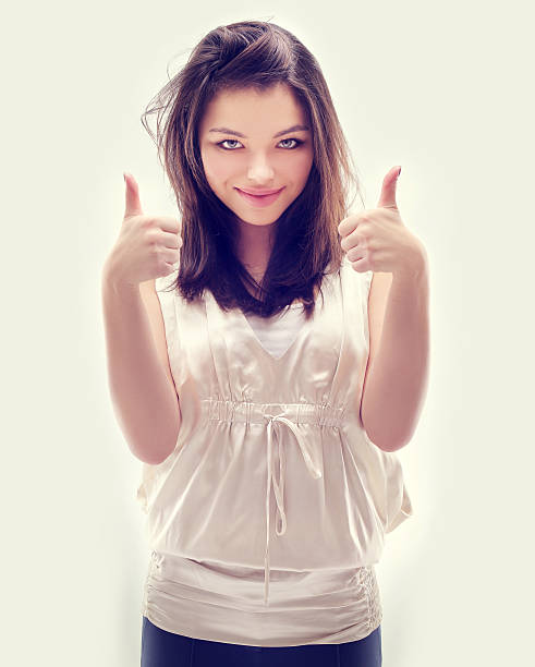 istock Girl  laughing at camera with thumbs up. 484374097