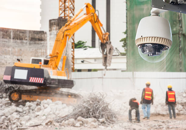 CCTV Camera operating Workers Working on Construction Site stock photo