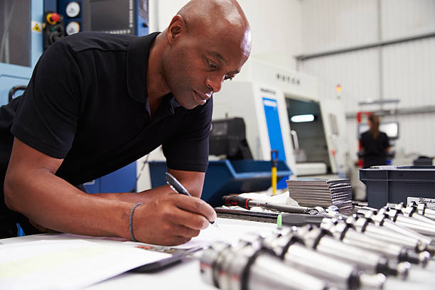 istock Engineer Planning Project With CNC Machinery In Background 484376240