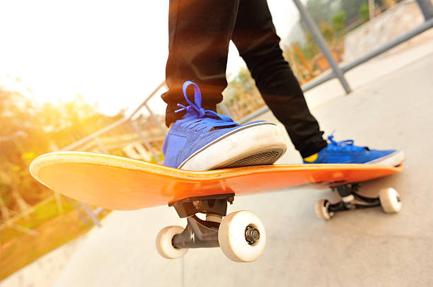 istock Legs in sneakers on a skateboard 484376355