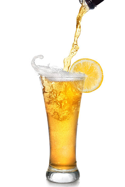 istock Beer pouring from bottle into glass with lemon 484377205