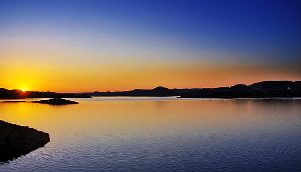 istock sunset over the water at dam 484377517