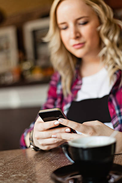 istock Girl using smart phone in a cafe 484378497